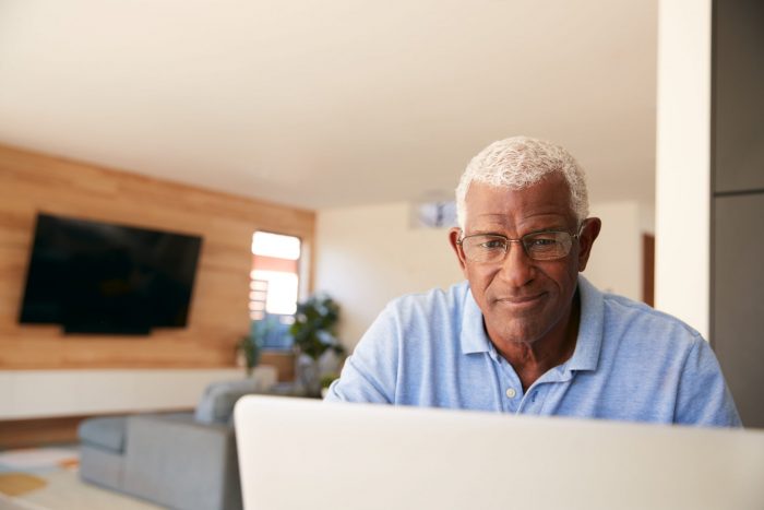 Older African American man working on his laptop